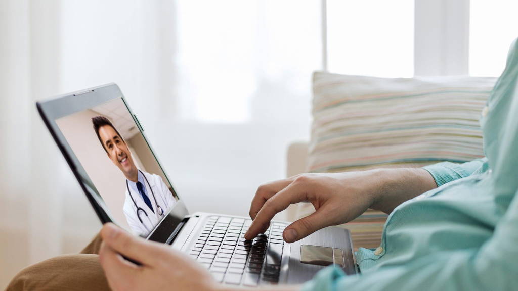 patient having video call with doctor on laptop