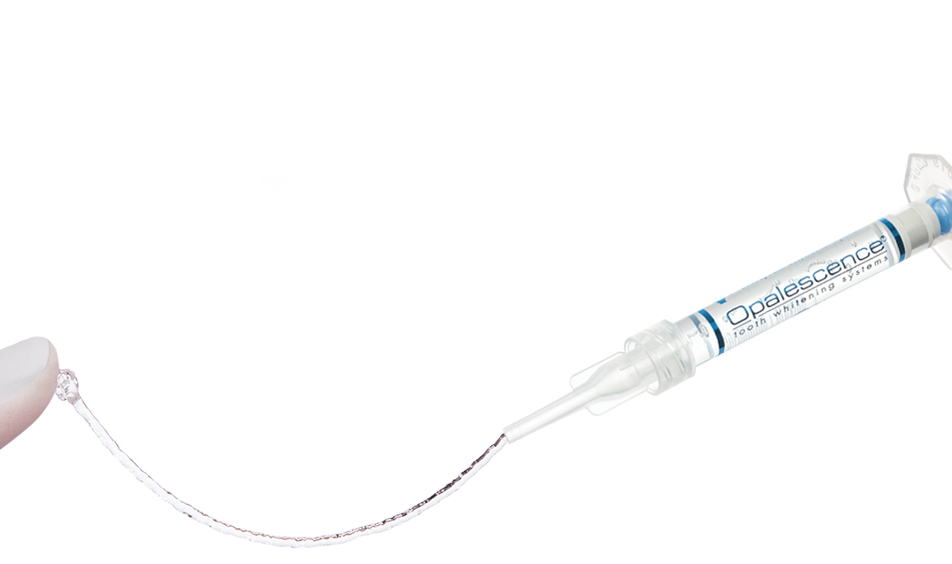 Syringe dispensing sticky, viscous transparent gel to a with gloved finger