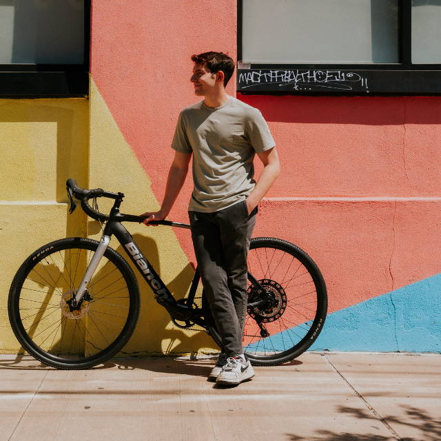 A man standing next to a Bianchi E-Impulso electric bike