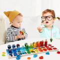 Boy and girl playing a fishing game within the Montessori Smart Board set.