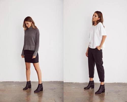Woman wearing grey charcoal turtleneck jumper and black mini skirt with black ankle boots and woman wearing white short sleeve top and black cropped trousers with black ankle boots from sustainable fashion brand Vetta