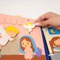 Woman's hand placing a lion puzzle piece onto a wooden board to complete the 5 piece twist matching puzzle game. 
