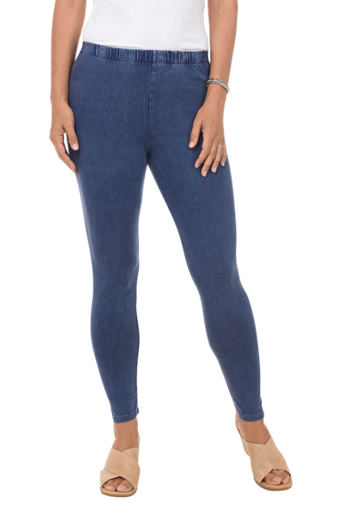 A woman wears a pair of blue mineral wash leggings.