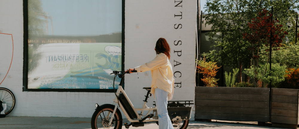 A woman standing next to a Specialized Globe Haul ebike