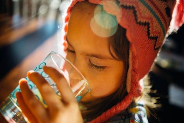 Young girl drinking water