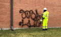 Klein Pressure Washing removes graffiti from brick building