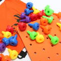 Orange Montessori Pegboard and pegs of different colors placed on it. 
