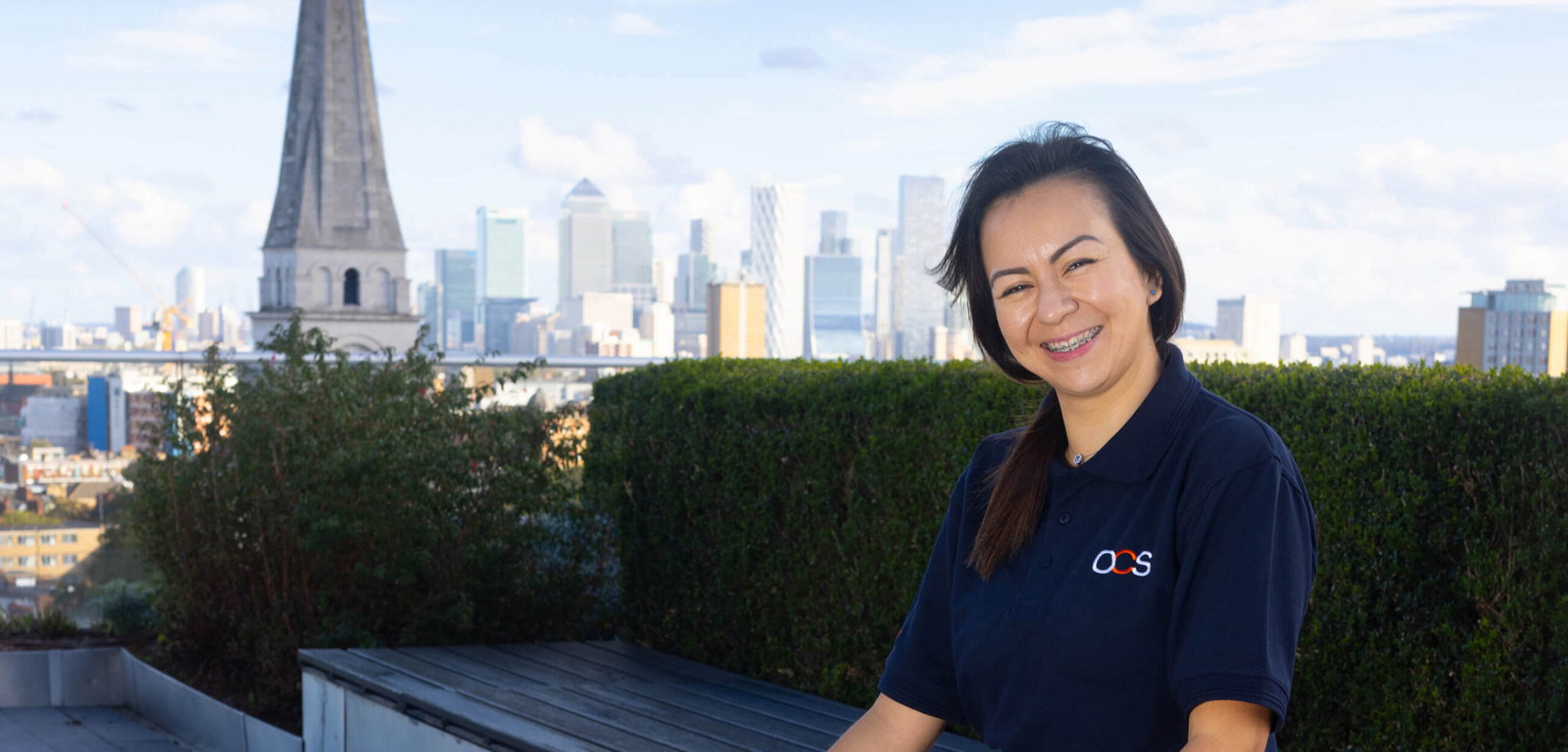 OCS colleague in an OCS uniform smiling for a picture.