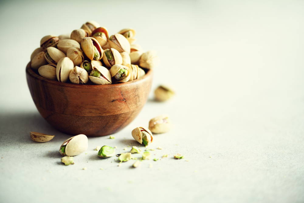 bowl of pistachios that are rich in melatonin to help you sleep to get clear skin 