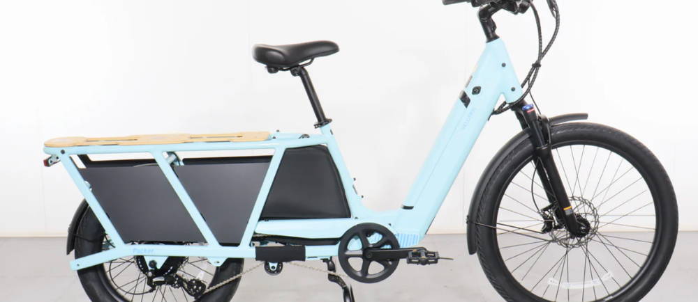 a sky blue Velotric Packer 1 longtail electric cargo bike
