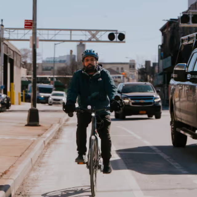 a man riding an electric road bike on a busy street