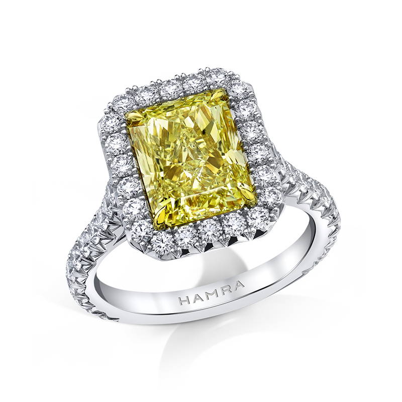 Yellow diamond engagement ring with white diamond halo 