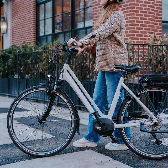 Female walking with an electric city bike