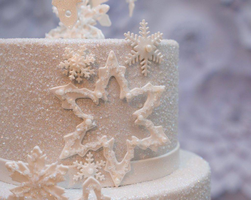 Christmas-themed cake with snowflake details and sugar coating.