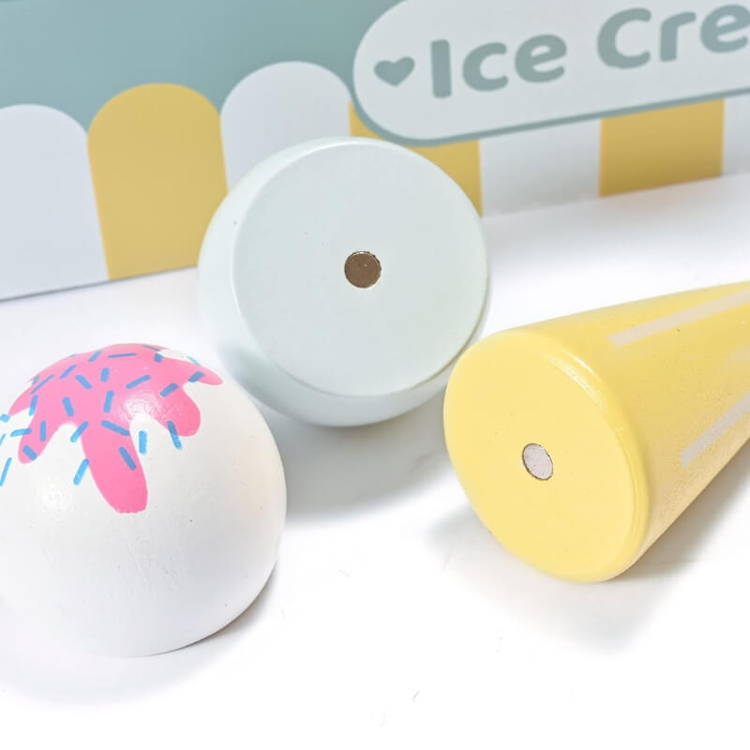Close up on wooden cones with magnets which are part of the pretend play wooden Ice Cream set toy for kids.