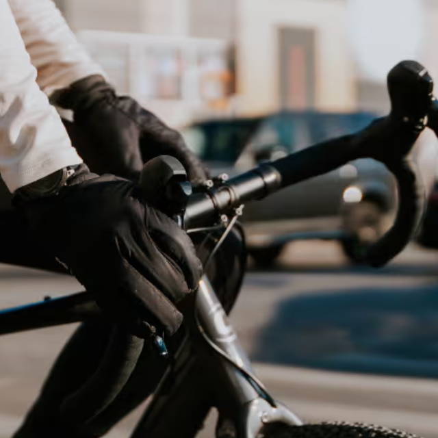 a person with their hands on the handlebars on an electric road bike