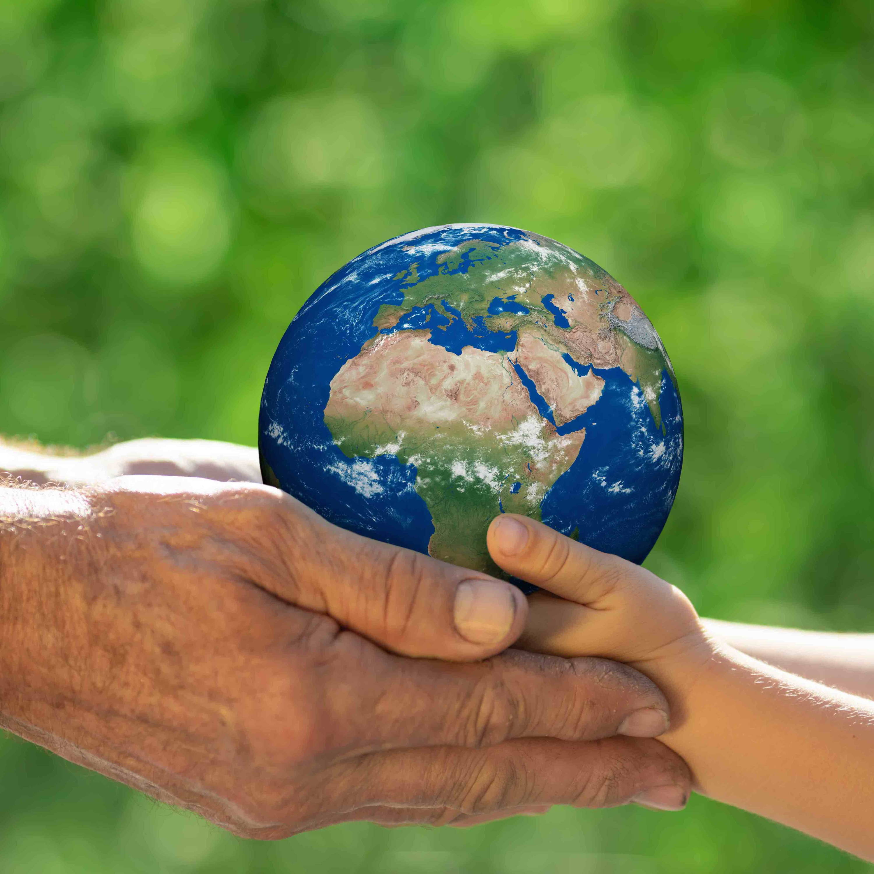 Adult and child hands holding globe