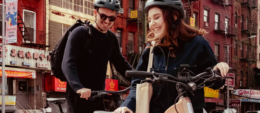 couple riding ebikes in the city