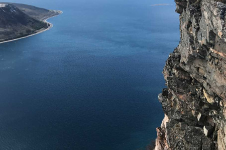 girl standing on the edge of a mountain.png