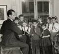 Rudolf Steiner playing music with a group of children.