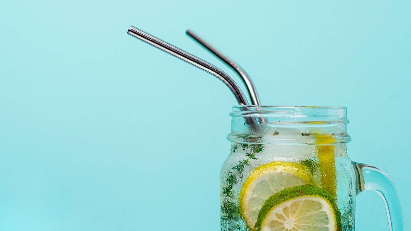 Stainless steel straws in mason jar filled with lemons and limes