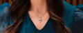 Woman wearing large diamond cross pendant