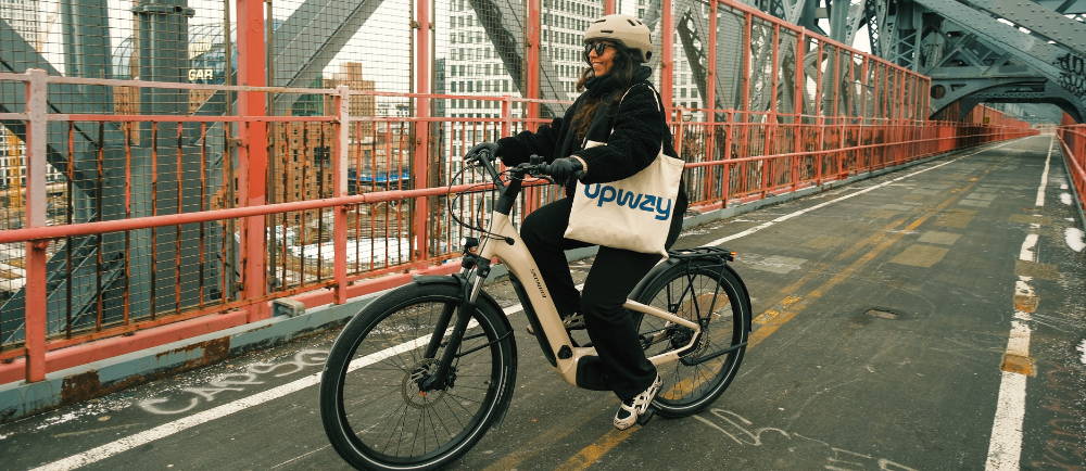 a woman riding a step-through e-Bike in the city