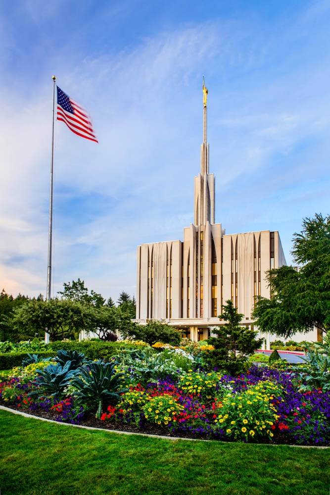 Photo of the Seattle Temple and grounds with an American Flag waving proudly.