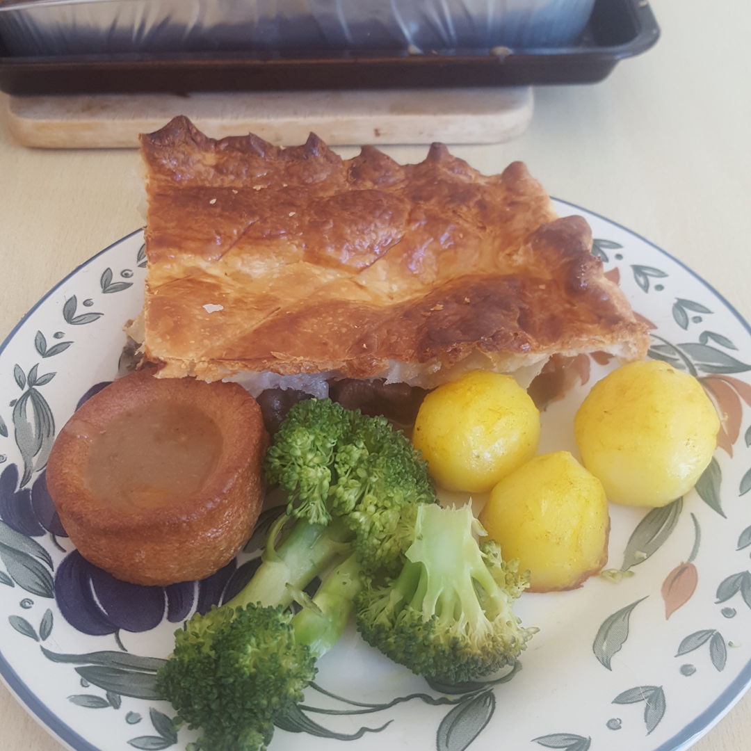 Steak pie with yorshire pudding, roast potatoes and steam broccoli.