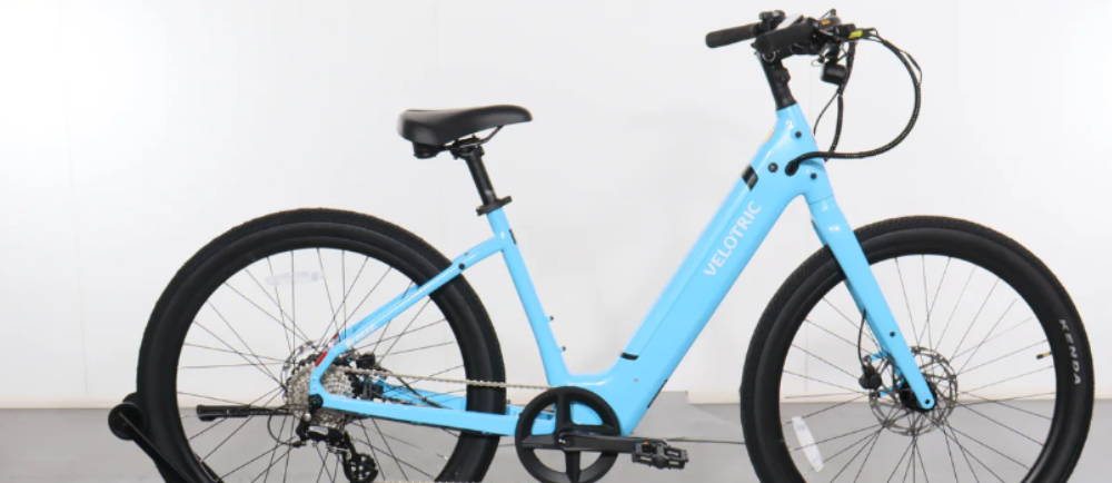 a sky blue Velotric Breeze electric bike