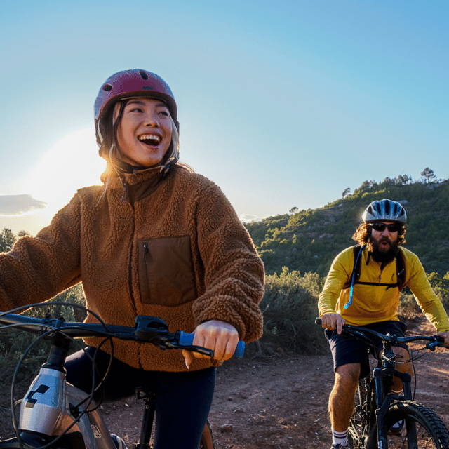 A man and a woman riding electric mountains bikes
