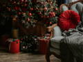 Red cushions and decor on a green Yule tree