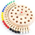 Colorful pegs lined around a wooden board memory game for children.