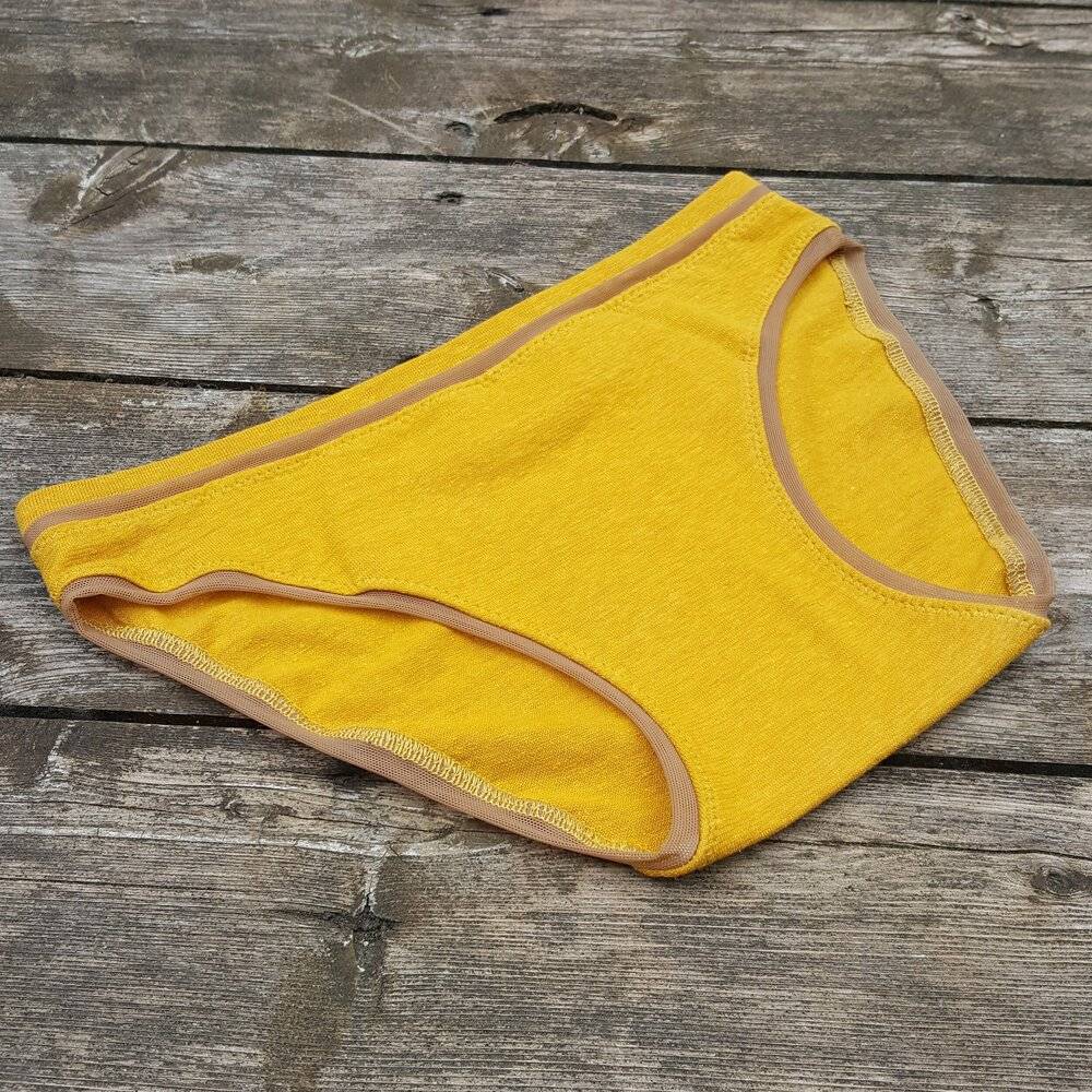 a paid of Valkyrie high waisted underwear in mustard yellow