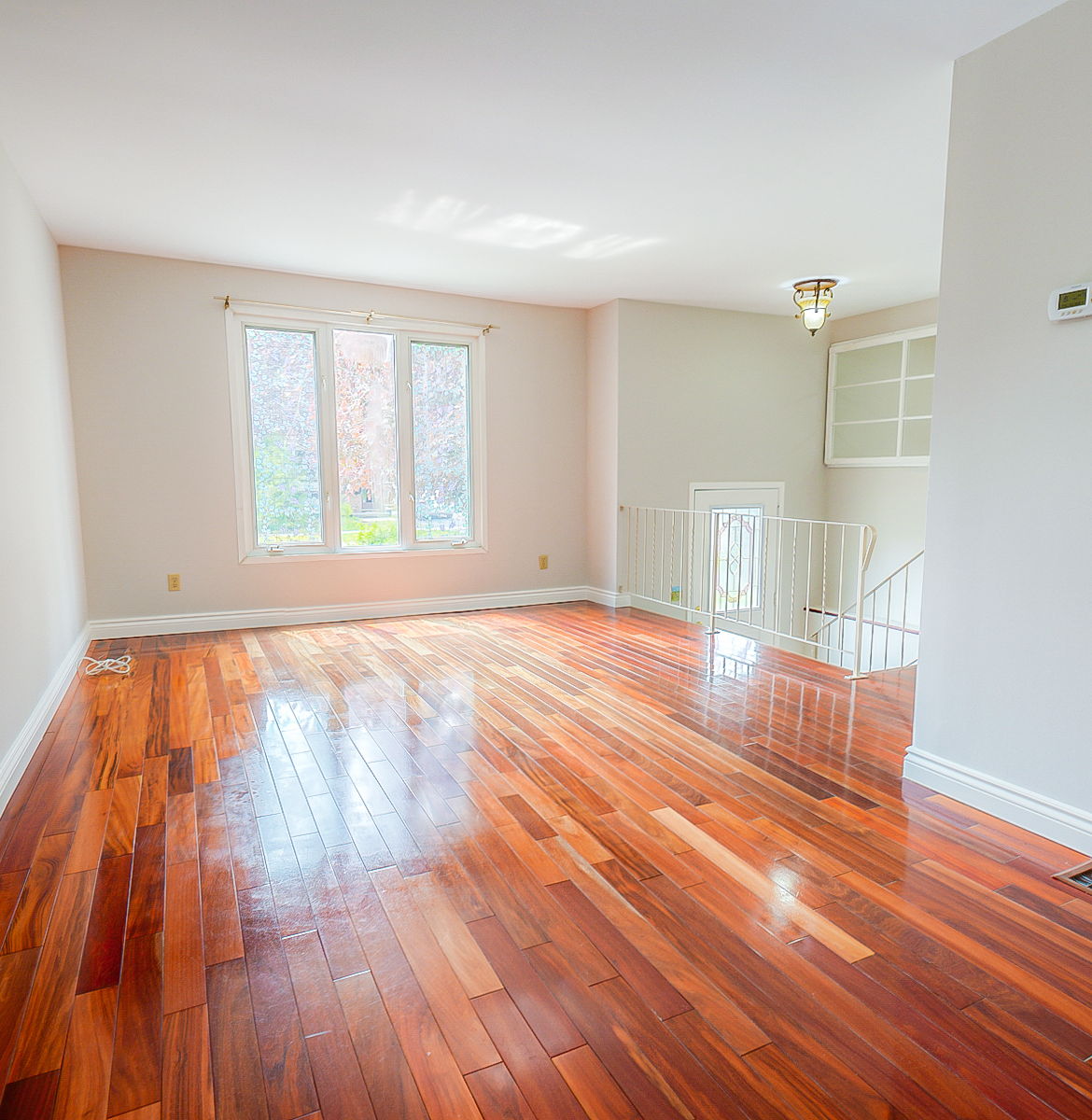 spare room with hardwood flooring and natural light