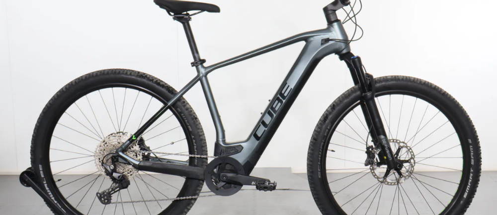 a silver Cube Reaction Hybrid Pro electric mountain bike
