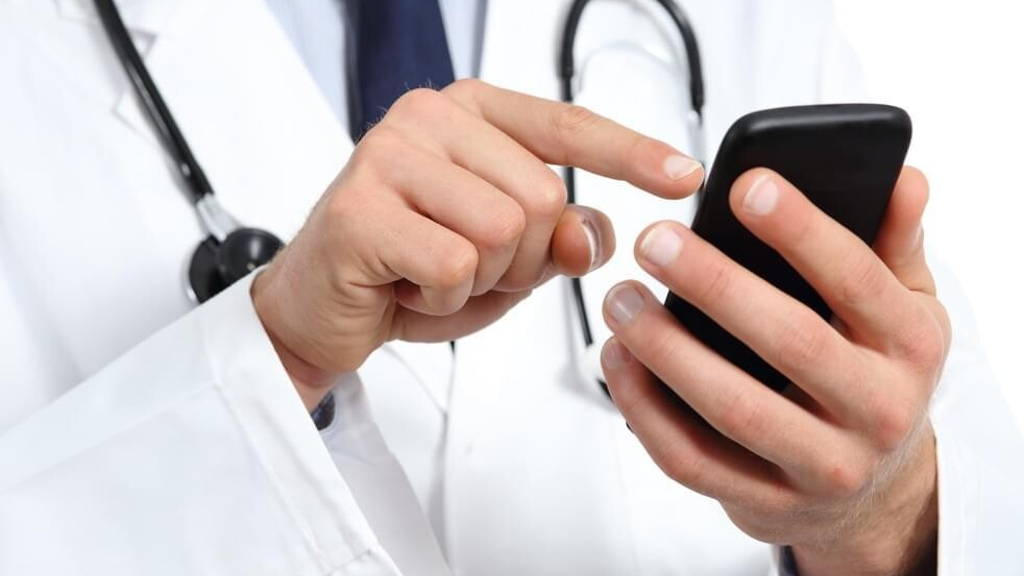 Doctor hands texting on a smart phone