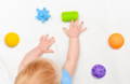 Baby reaching for textured toys to build hand eye coordination