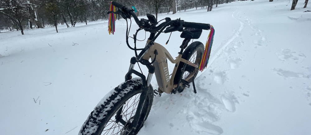 an aventon aventure fat tire electric bike in the snow