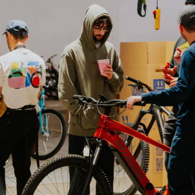 four people at an upway upcenter with three of them looking at a specialized electric mountain bike