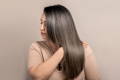 latina woman showing sleek hair after keratin session