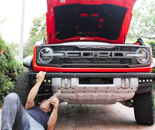 mike owner of m&R automotive installing fog light kit on ford bronco raptor