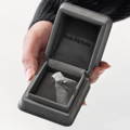 Woman holding a Reis-Nichols Jeweler engagement box showcasing a beautiful engagement ring