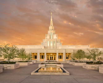 Phoenix Temple standing in front of orange and purple clouds.