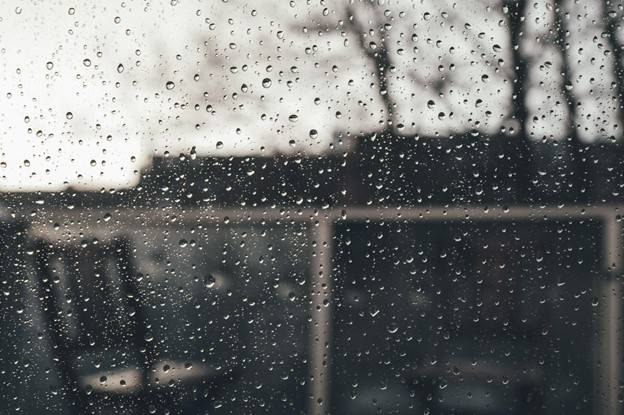 Rainy window and bad weather that affects joints