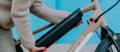 Rider removing Aventon Pace electric bike battery