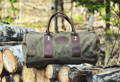 imout duffel bag sitting on a stack of firewood outside
