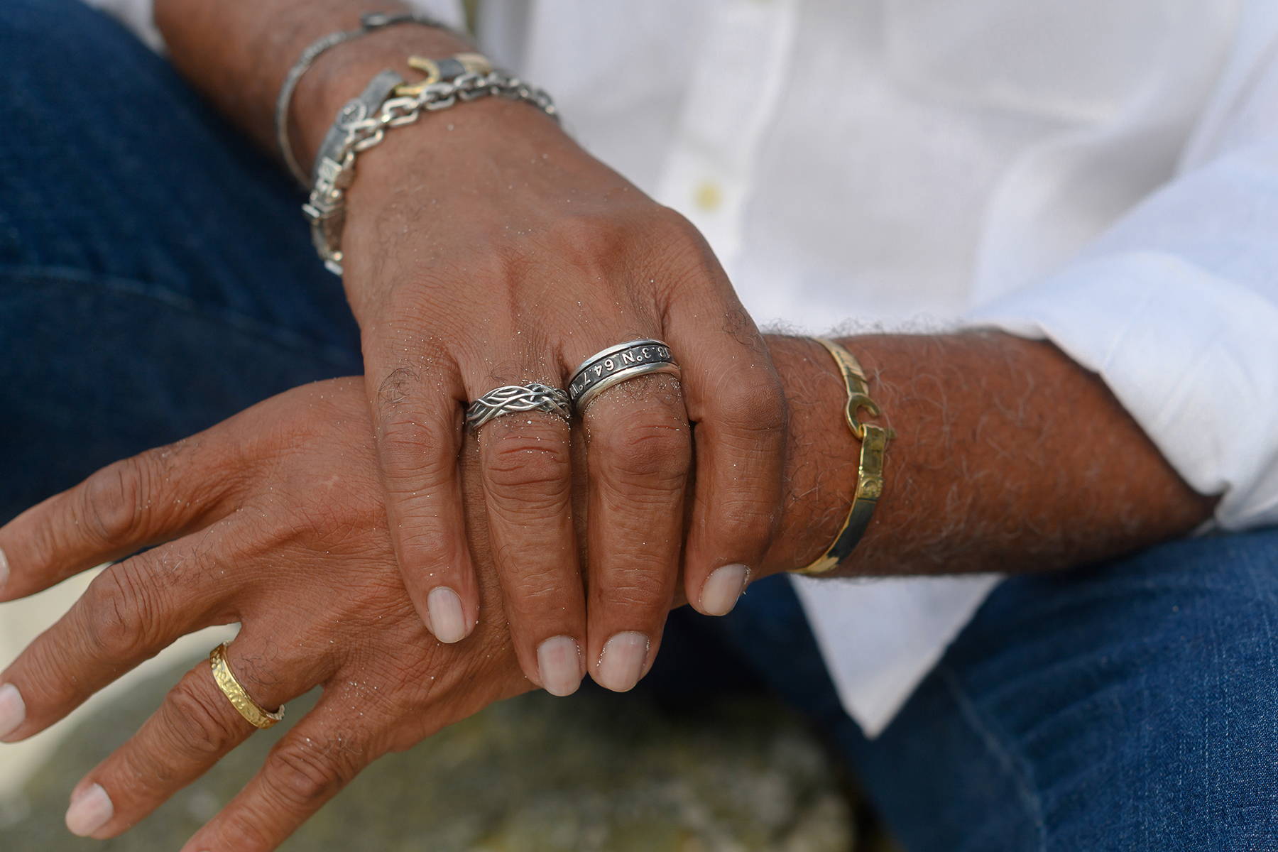 Man wearing Vibe Jewelry's island inspired rings and bracelets.
