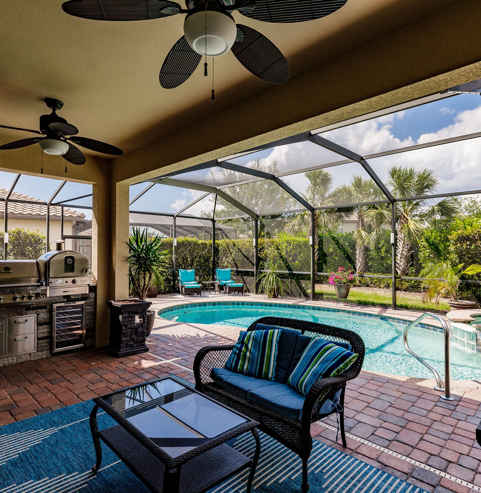 view of pool featuring an outdoor kitchen and a ceiling fan
