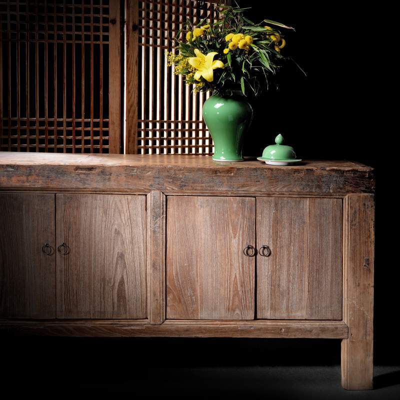 Rustic Mongolian sideboard with a green reproduction Chinese temple jar vase